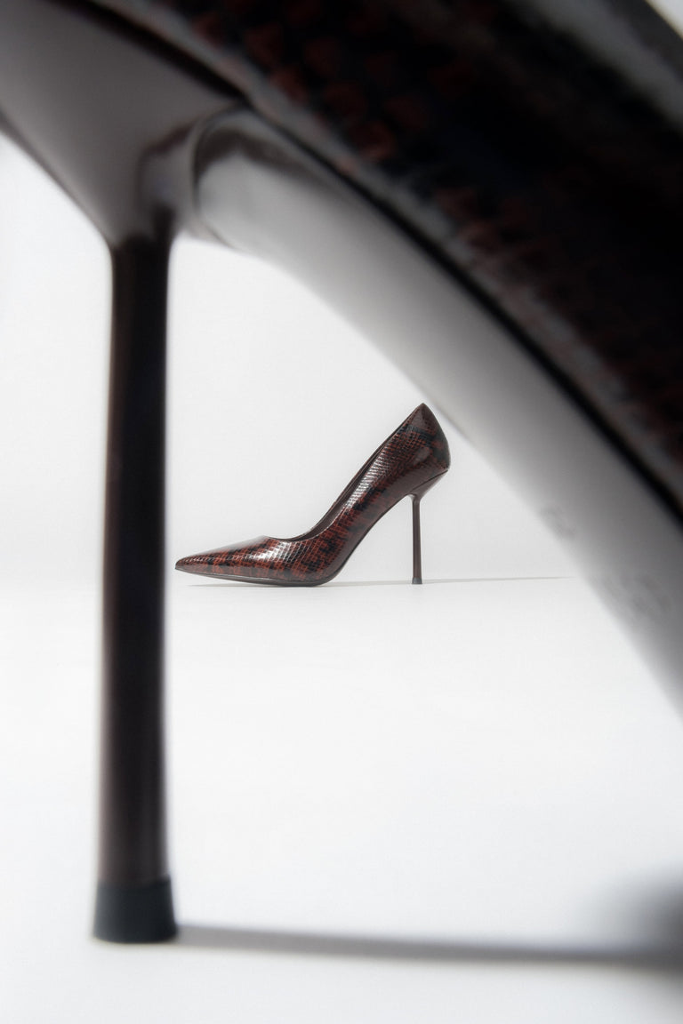 A pair of women's high heels in a brown snake-effect finish.