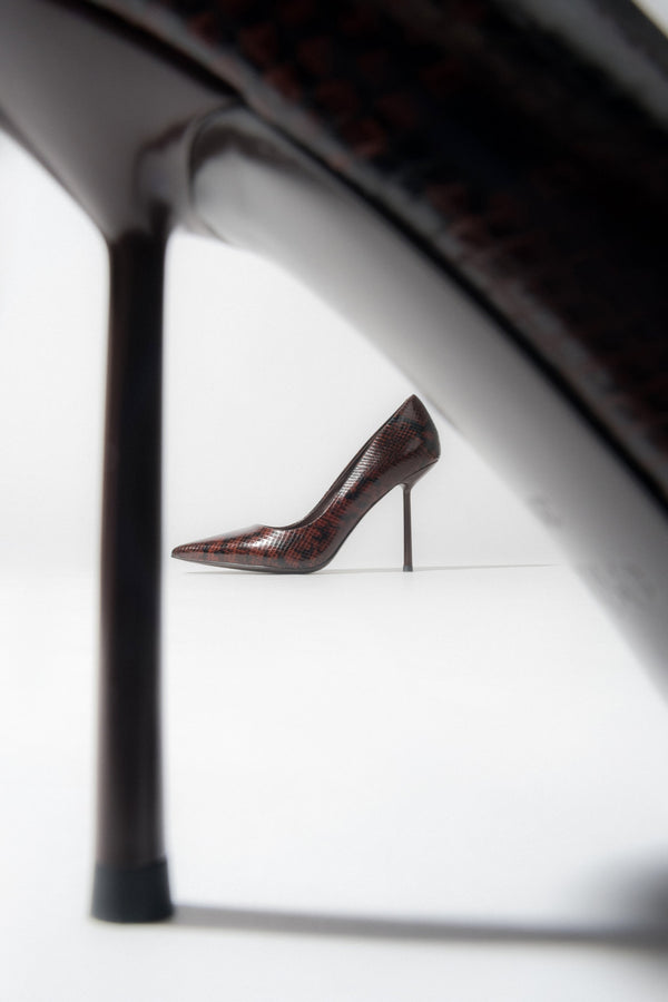 A pair of women's high heels in a brown snake-effect finish.