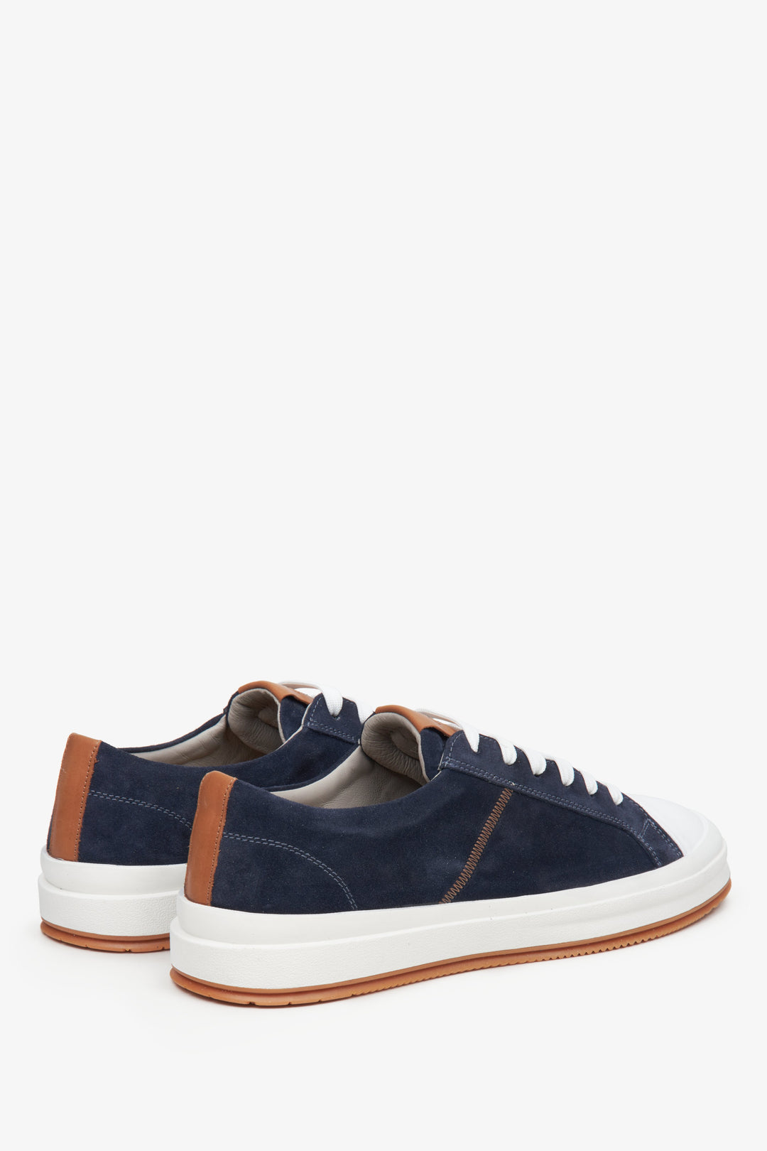 Navy blue men's sneakers made of genuine velour - close-up on the heel and side line of the shoes.