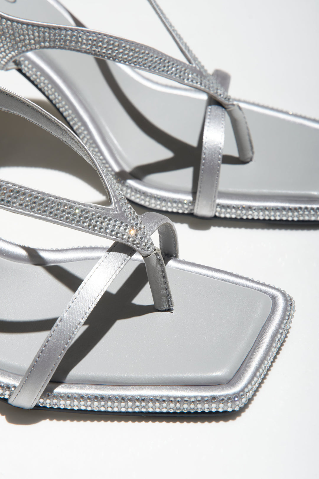 Women's silver heeled sandals with diamonds - a close-up on details.