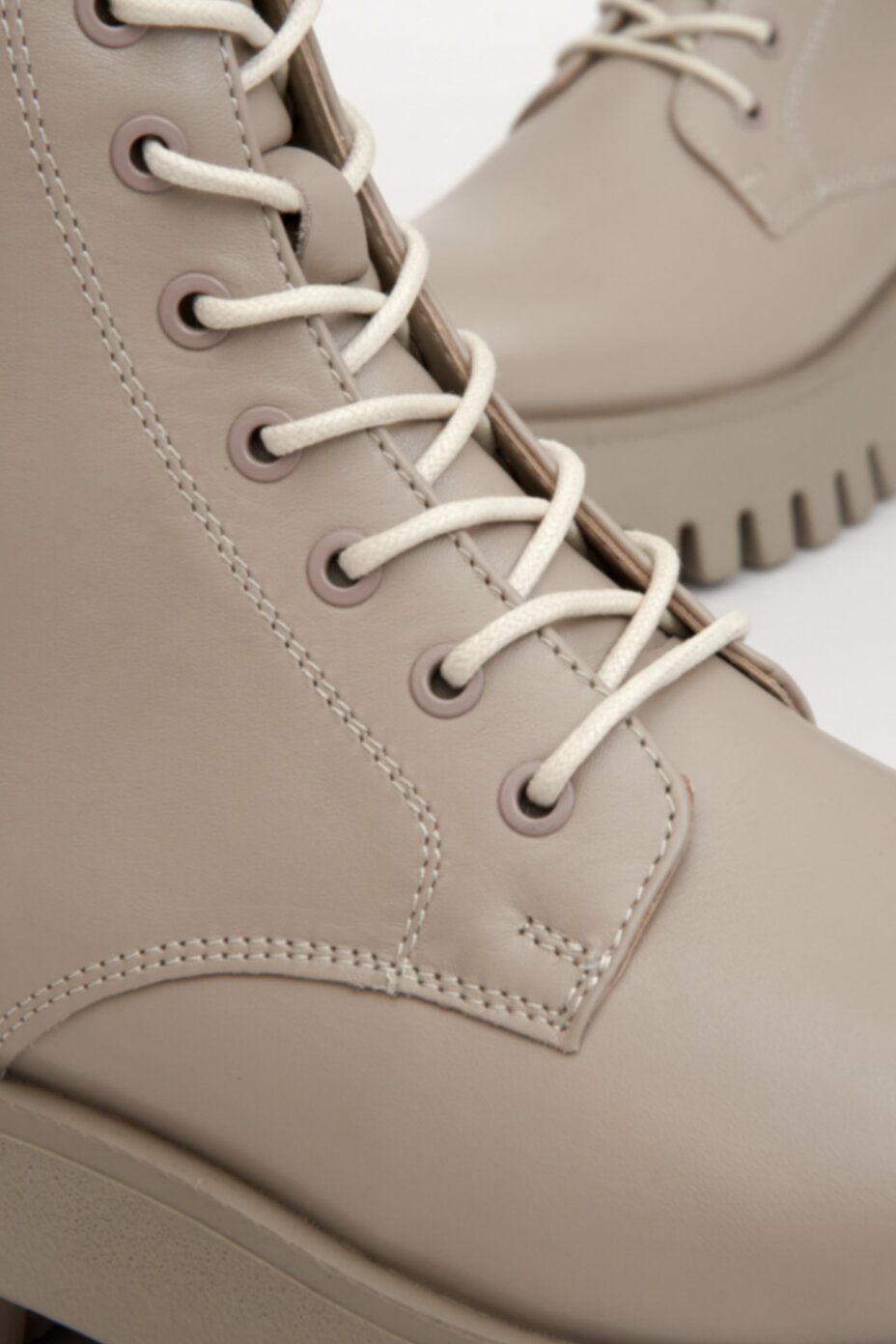 High lace-up boots made of natural beige leather by Estro - close-up on details.