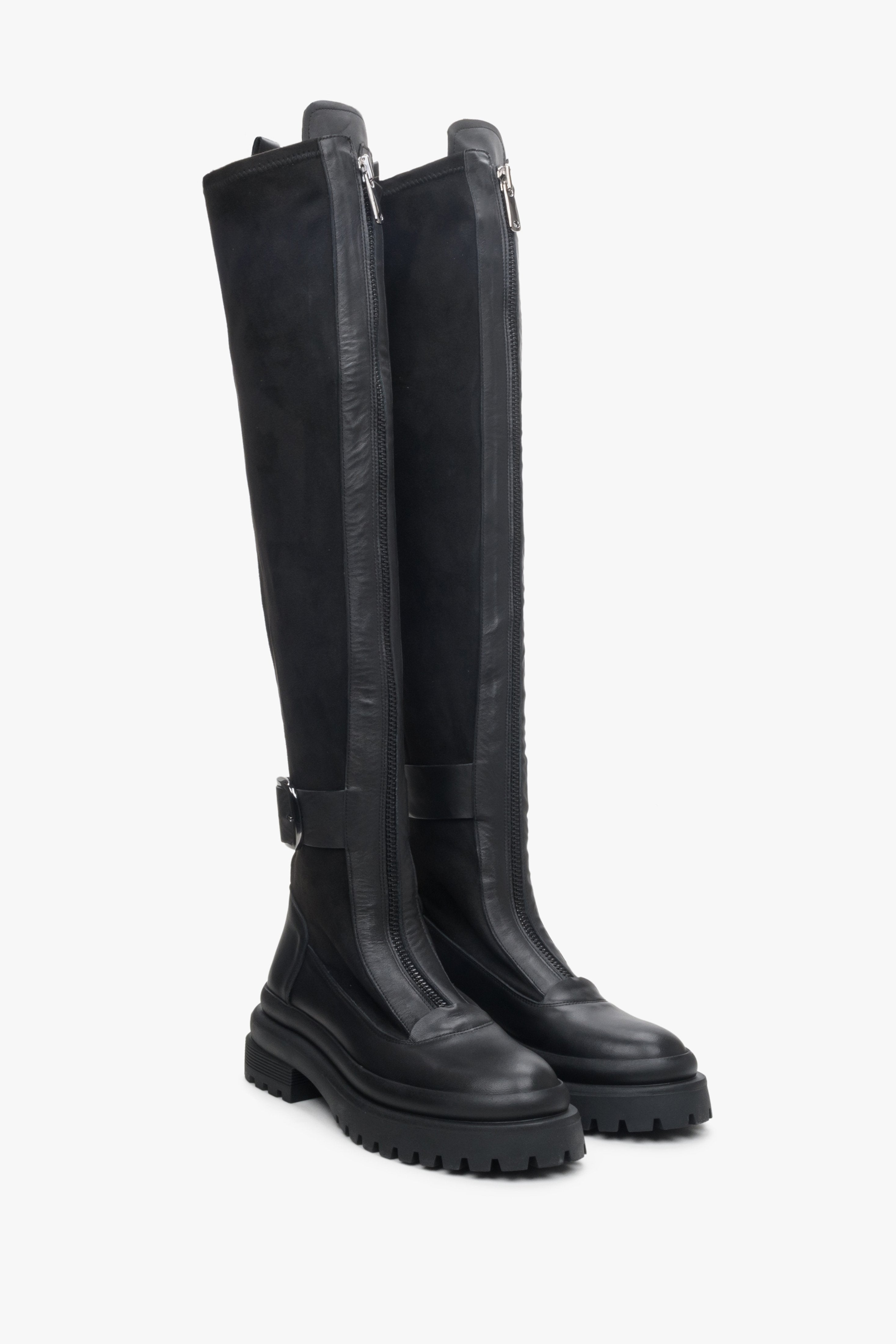 Black leather and velour knee-high boots.