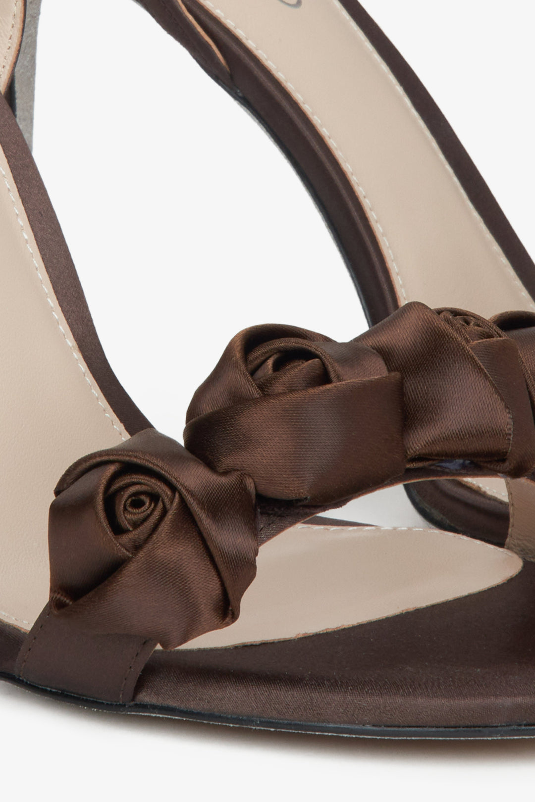 Women's dark brown high-heeled sandals - close-up on the ornament.