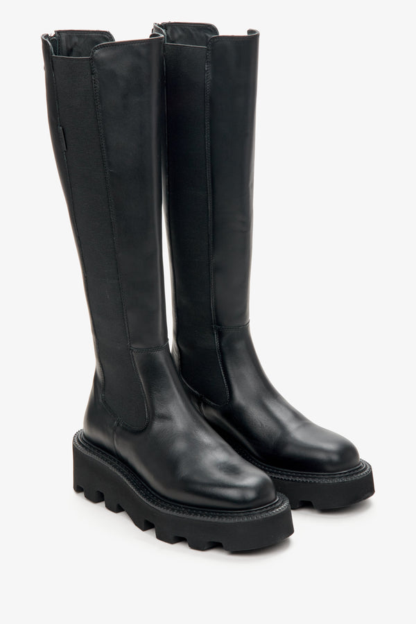 Estro black leather knee-high boots.