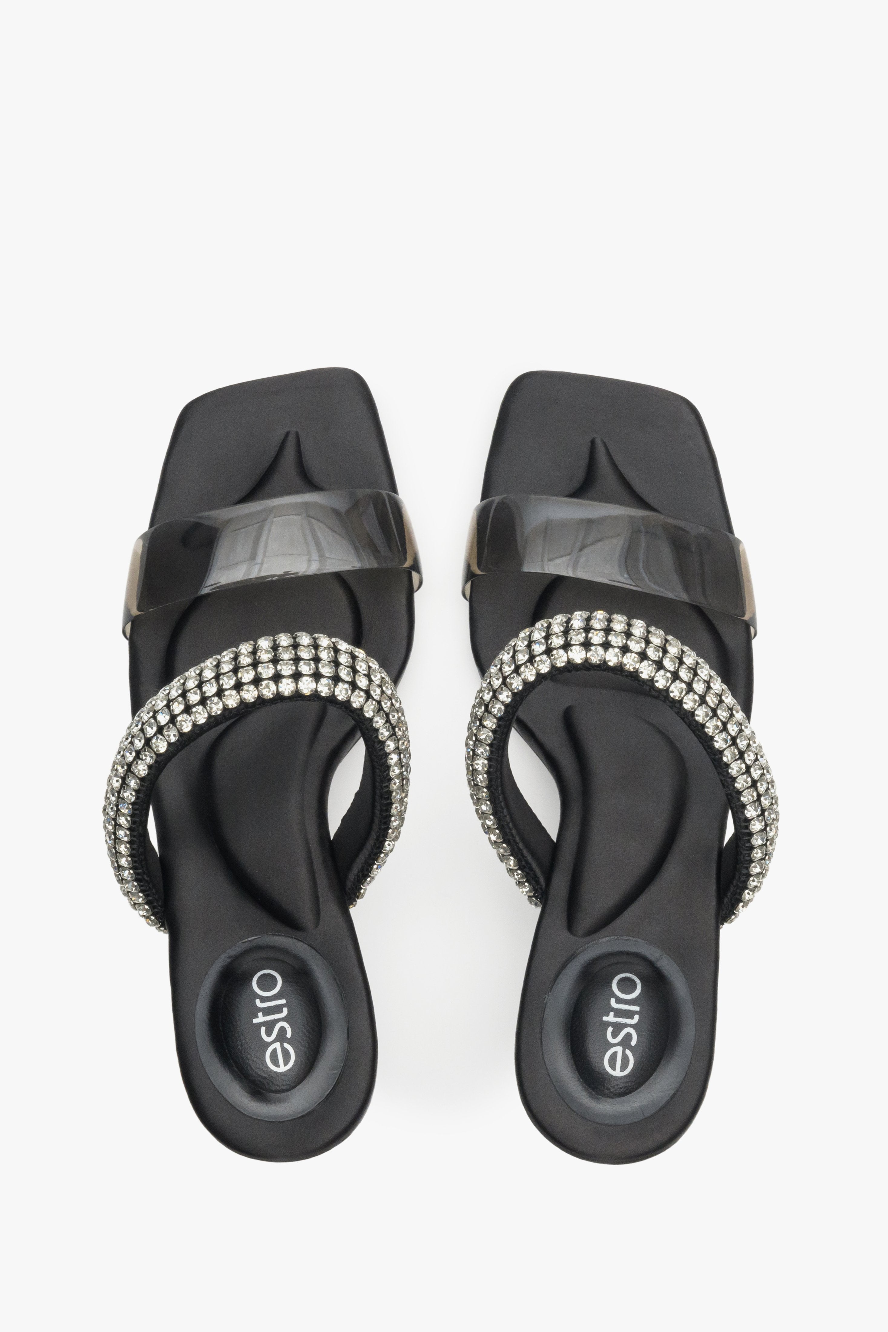 Women's elegant heeled black mules with ornament.