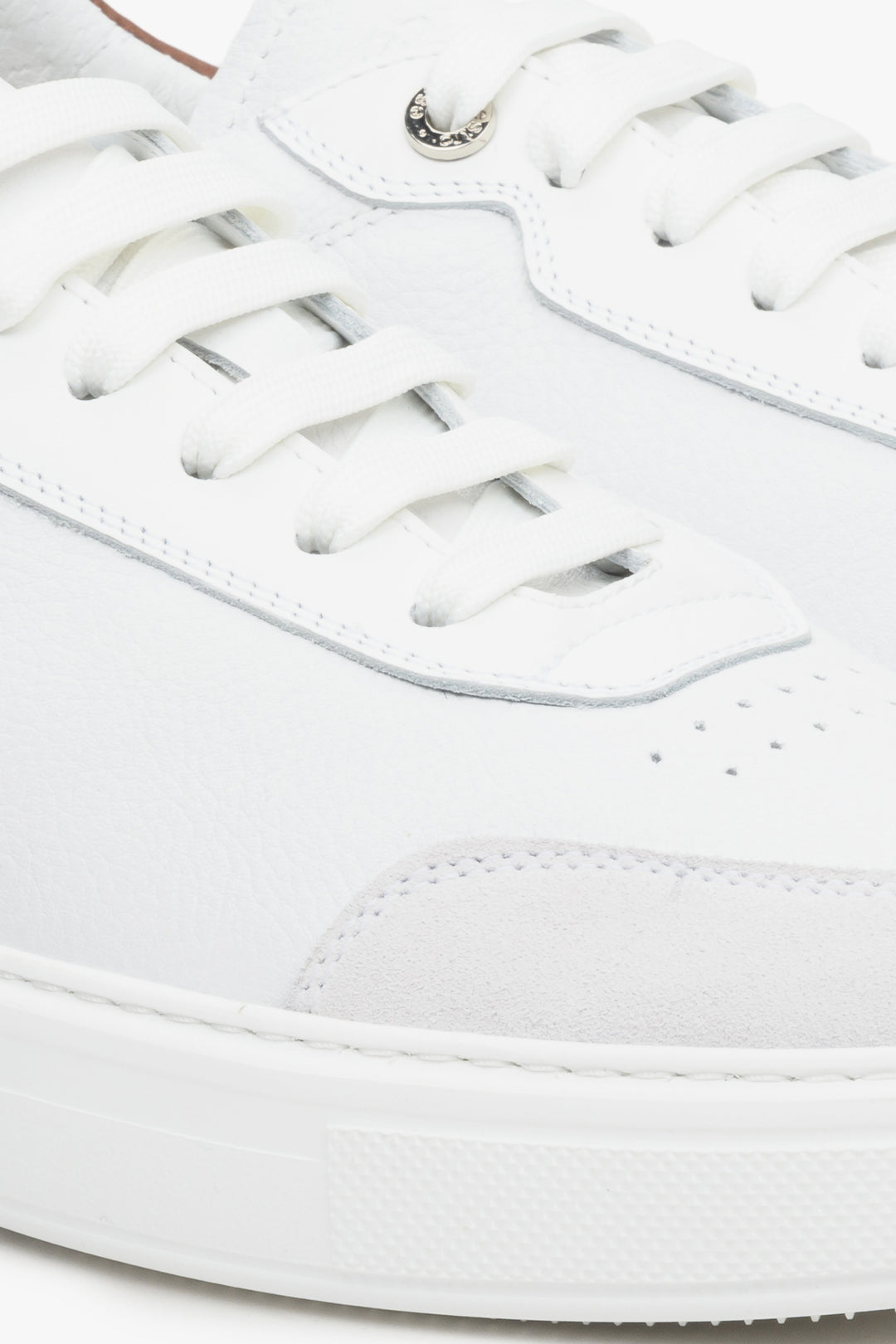 Men's leather and nubuck whote sneakers on an elastic sole - close up on details.