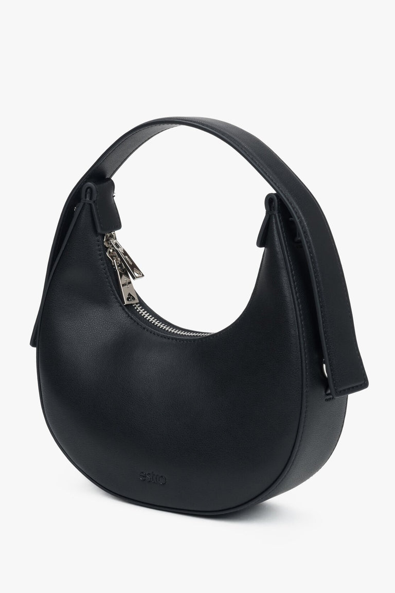 Black women's handbag with a unique crescent shape, available in the Estro collection.