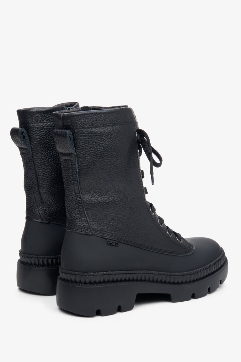 Women's black leather ankle boots with decorative lacing - close-up of the side of the boot and the heel.