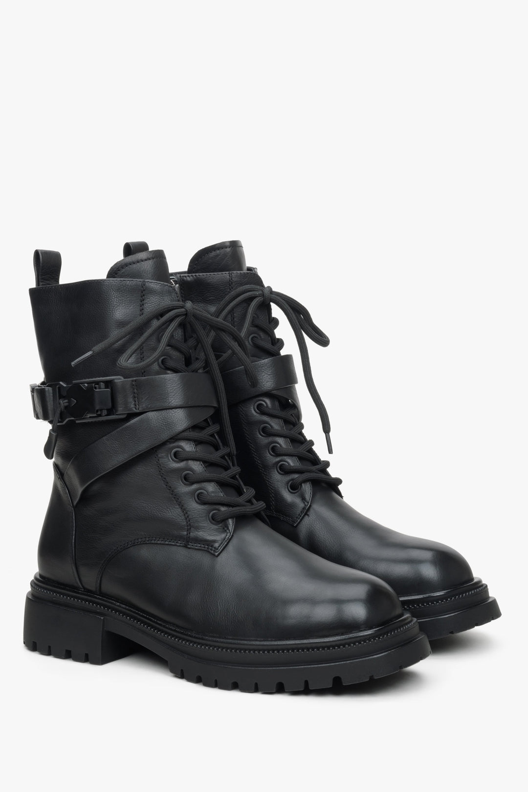 Women's black leather boots with insulation and decorative straps.