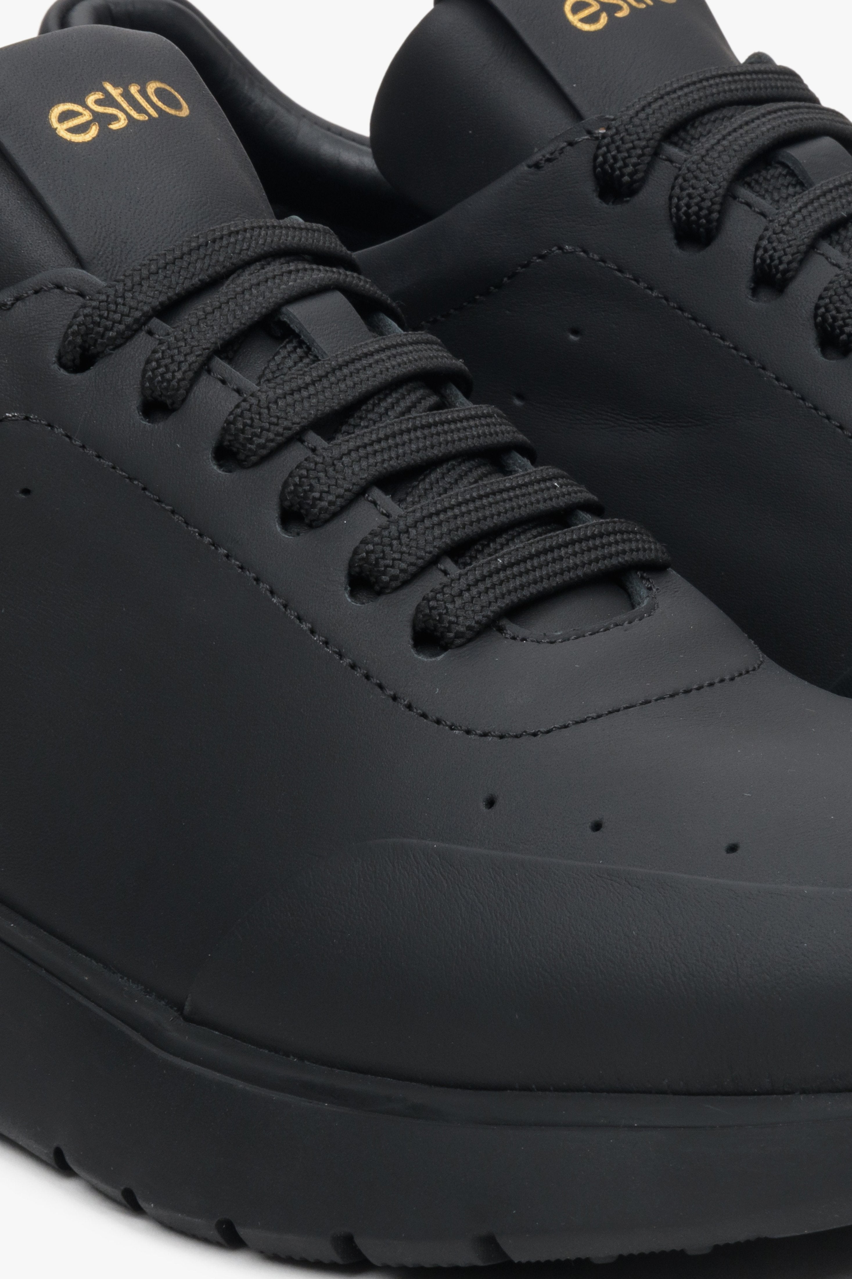 Women's black leather sneakers by Estro - close-up on the detail.