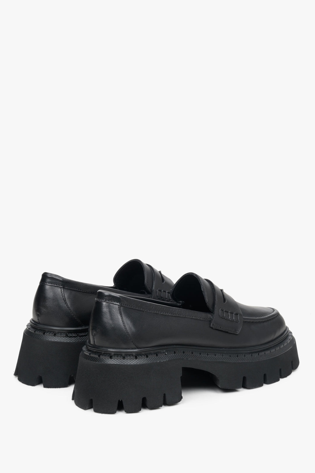 Women's black leather moccasins by Estro - close-up on the heel counter and side line.