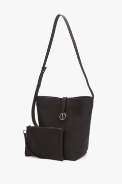 Women’s dark brown leather bucket bag with a removable cosmetic pouch.
