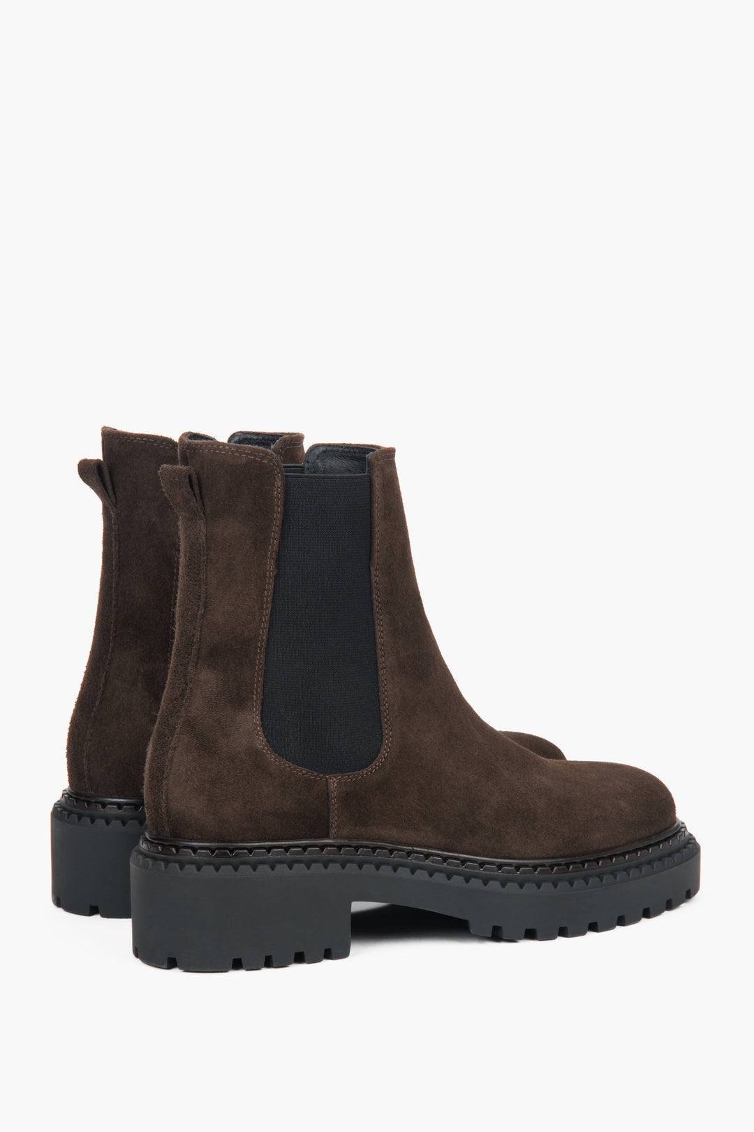 A side view of women's dark brown Chelsea boots, showing the platform sole and velour texture.