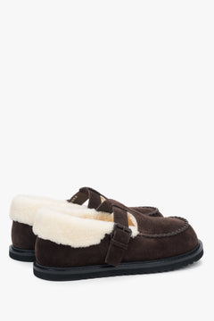 Side view of women's dark brown winter loafers showing the suede texture and fur elements.