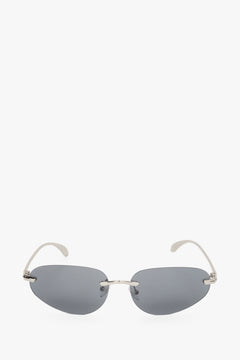 Dark grey narrow sunglasses for women with a rimless design.