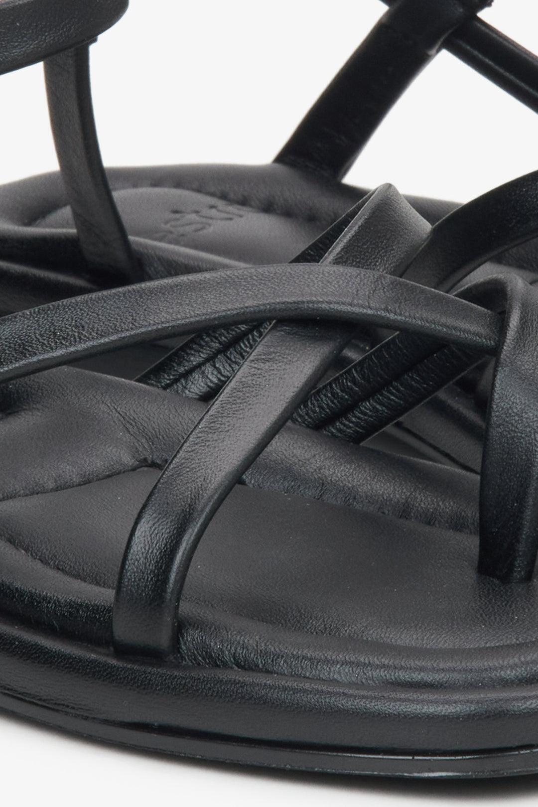 Women's black leather sandals with thin criss-crossed straps by Estro - close-up detail.