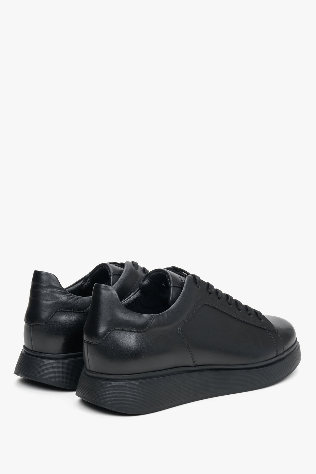 Men's low black leather sneakers by Estro - close-up on the side line and heel of the shoes.