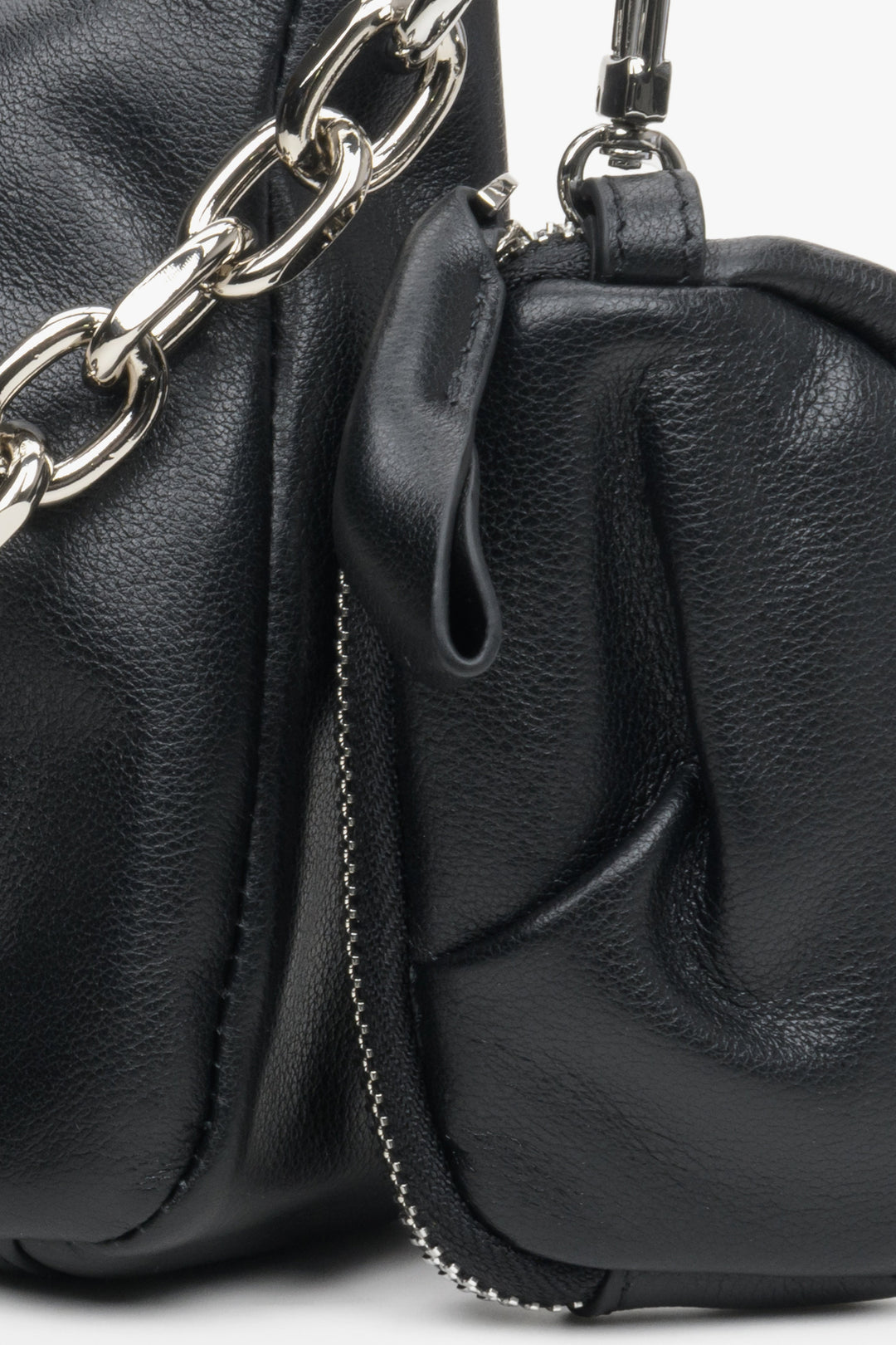 Small, stylish women's black leather bag with a chain strap - close-up of the additional pouch.