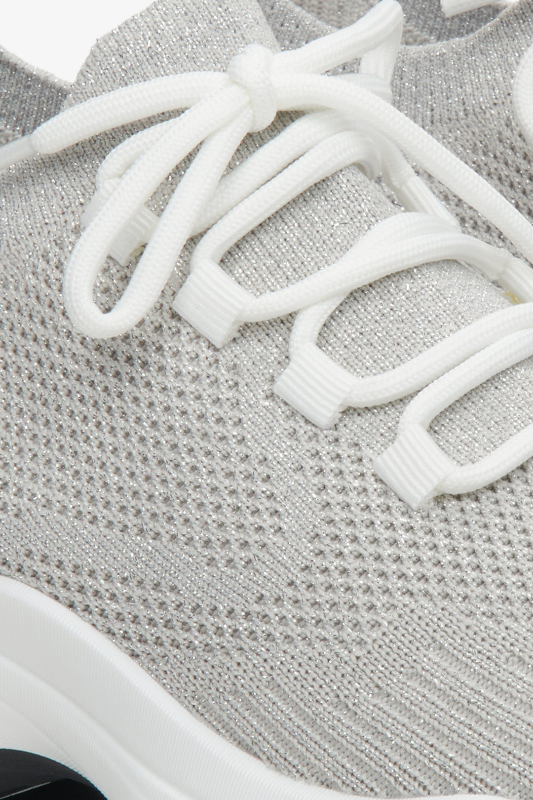 Grey women's mesh sneakers on elastic sole - a close-up on details.