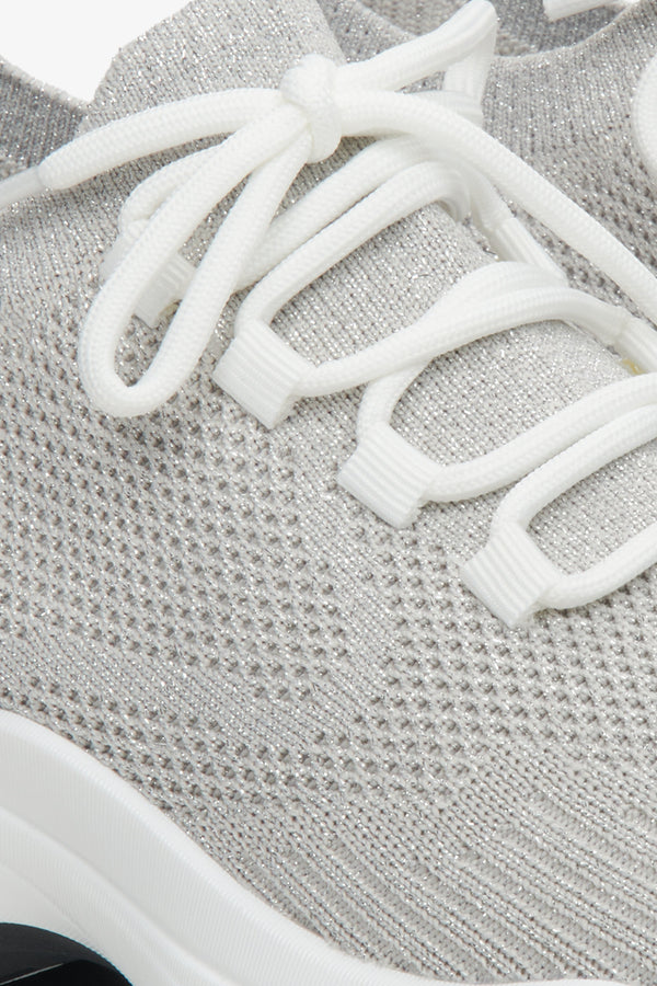 Grey women's mesh sneakers on elastic sole - a close-up on details.