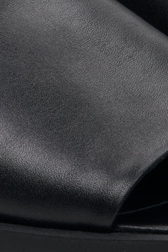 Women's black leather mules by Estro – close-up details.