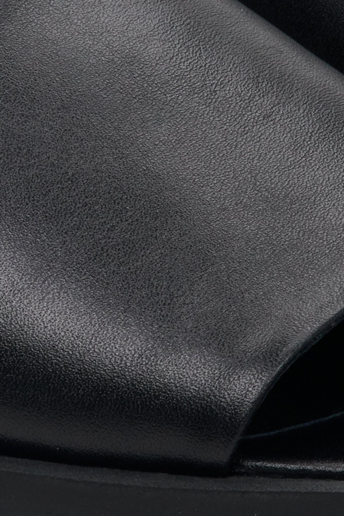 Women's black leather mules by Estro – close-up details.