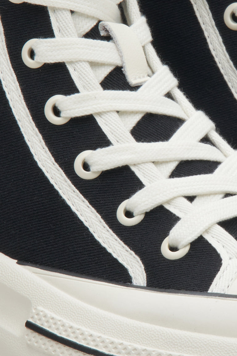 High-top athletic women's sneakers by Estro in black - close-up on details.