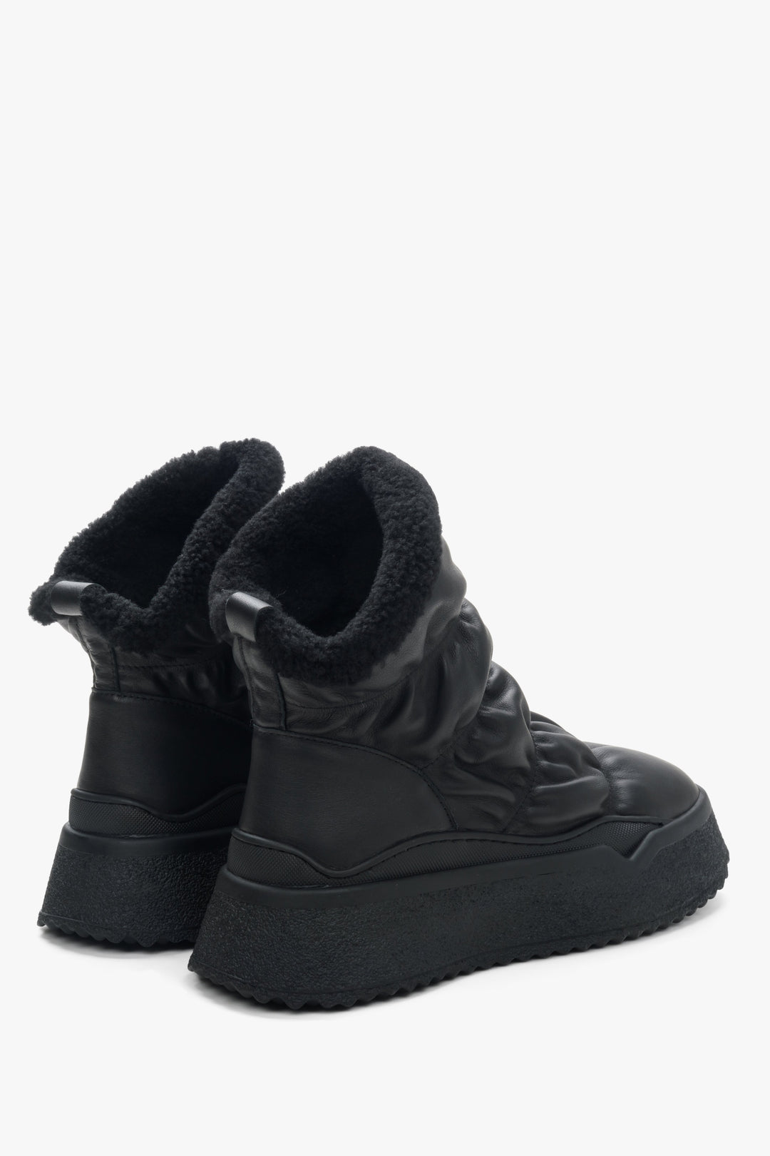 Women's black snow boots, fur lined - close-up on shoe sideline.