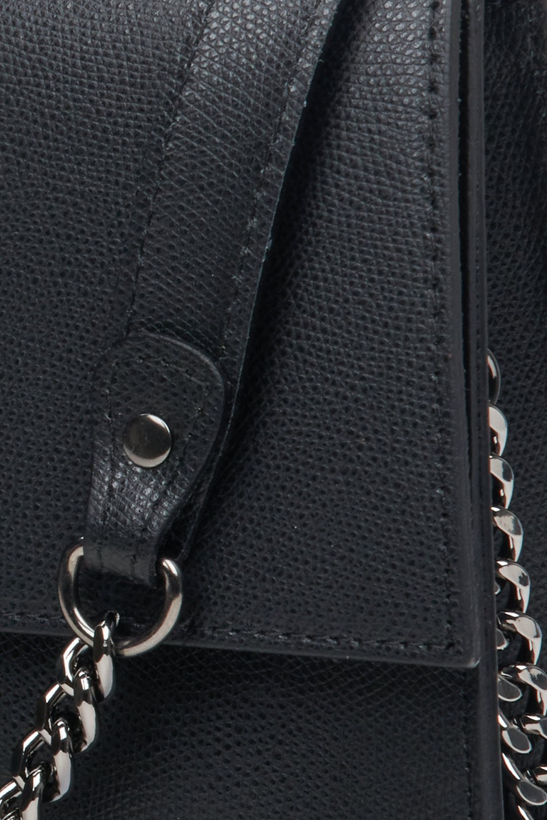 Women's black leather handbag with a flap by Estro - close-up on the details.