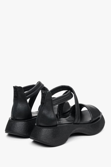 Comfortable, women's black leather  sandals for summer - presentation of footwear from the back.