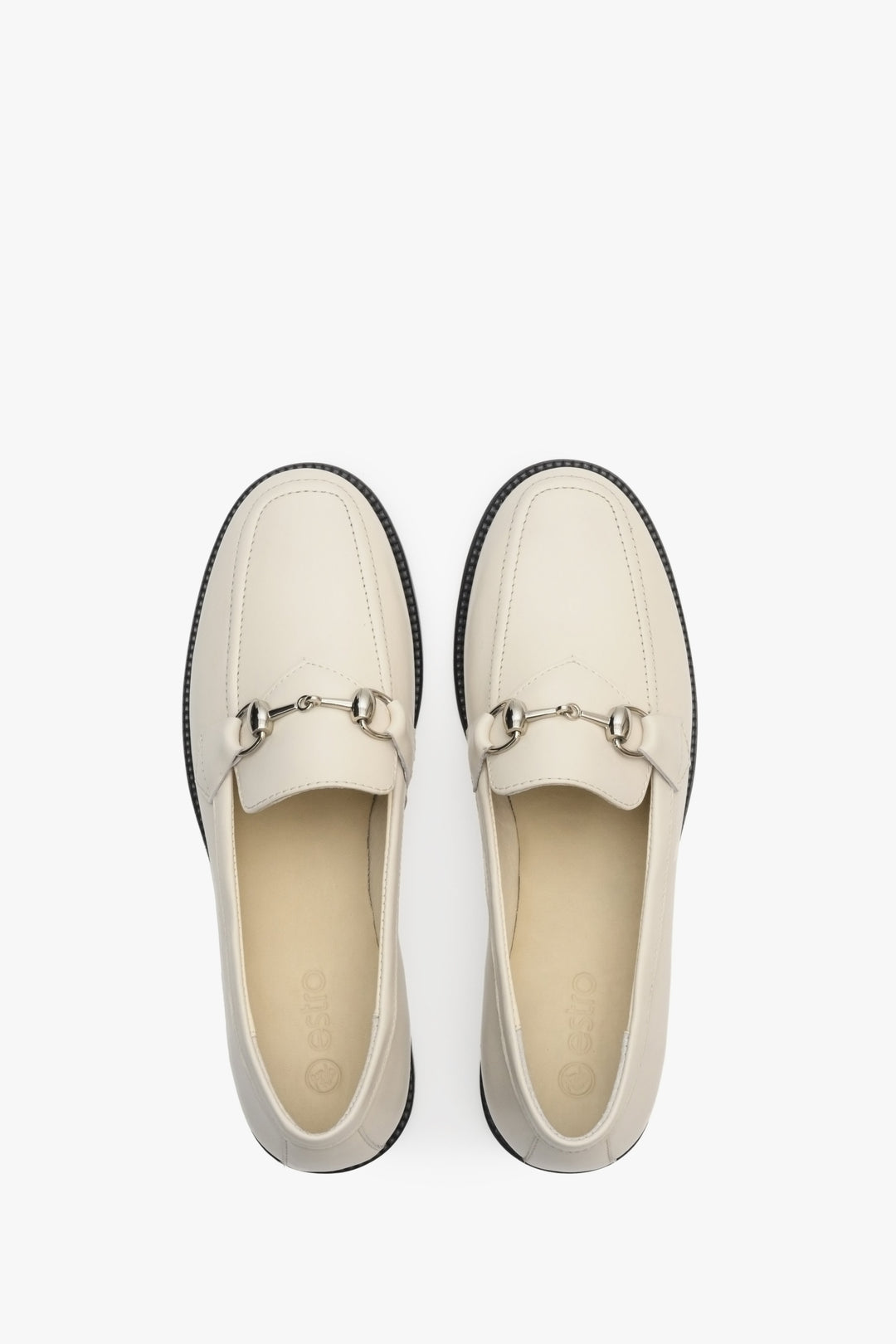 Elegant, white women's loafers made of Italian leather - close-up form above.