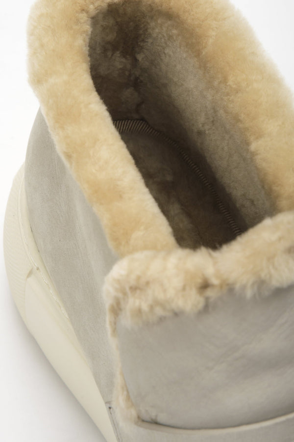 Grey low women's ankle boots Estro with fur made of nubuck - close-up of the decorative application.