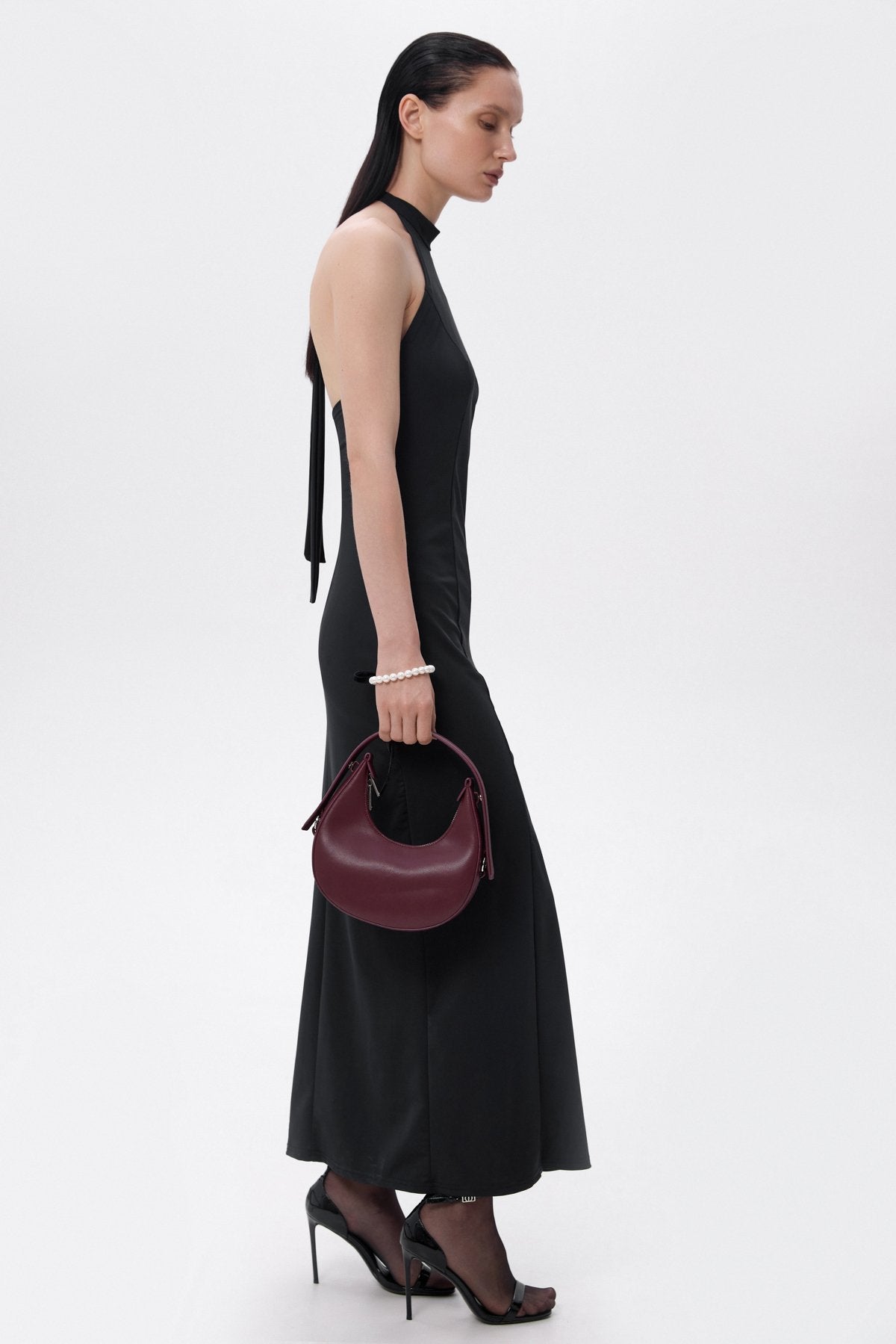 Stylish burgundy women's crescent-shaped handbag, available in the Estro collection.