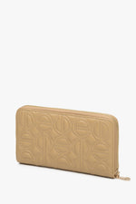 Large beige women's continental wallet with a zipper by Estro.