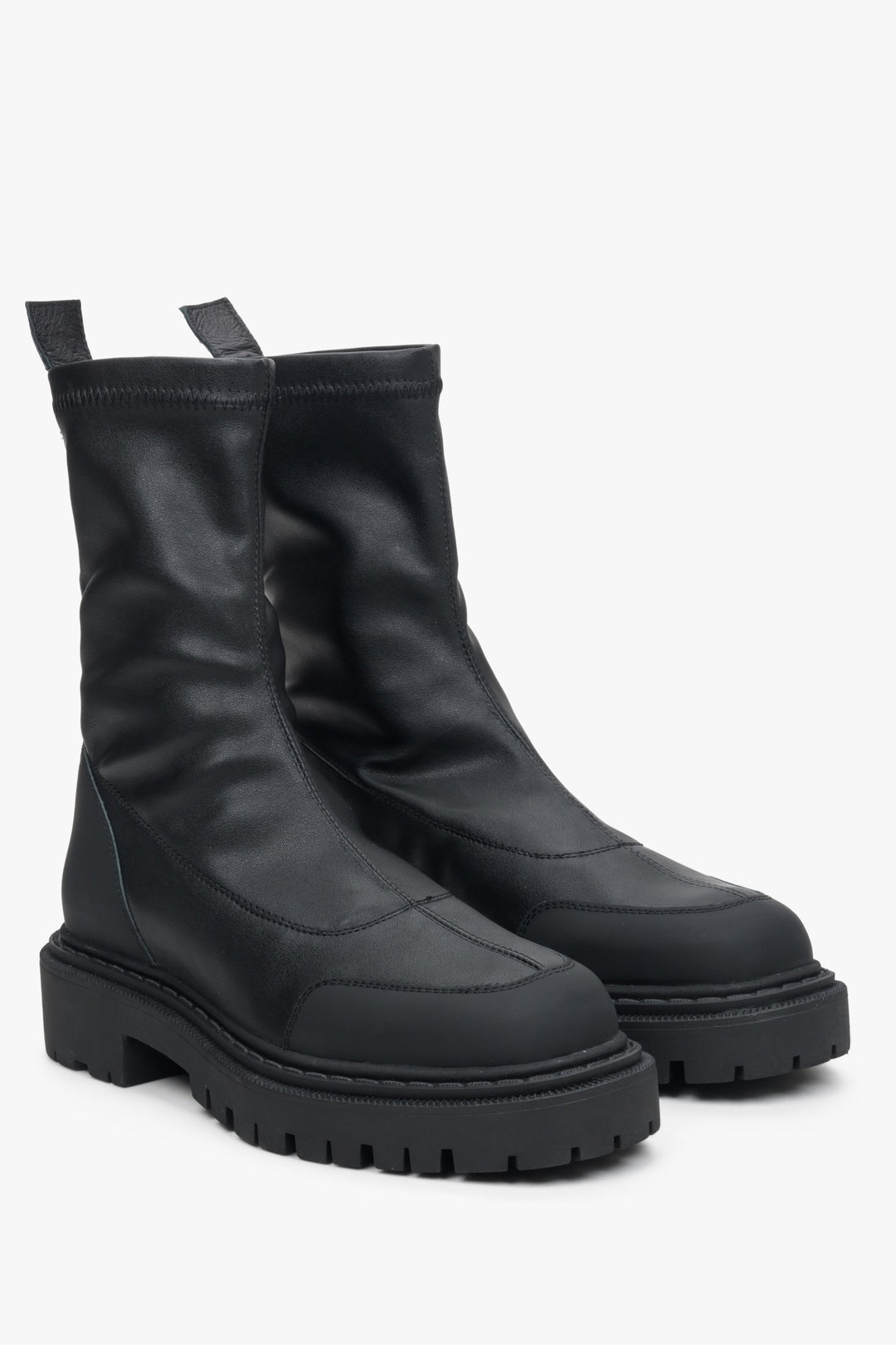 Black slip-on women's ankle boots with a flexible upper - close-up of the shoe's toe and side seam.