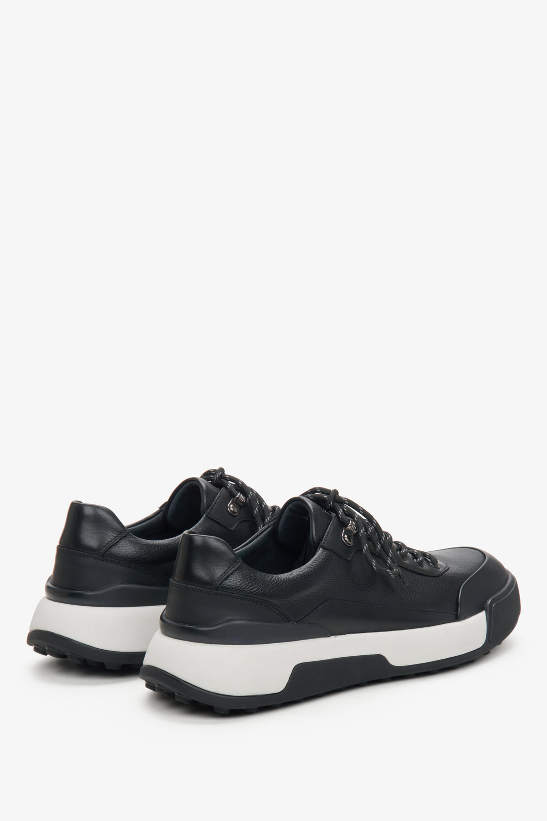 Men's black leather sneakers by Estro - close-up on the back and side line of the shoes.