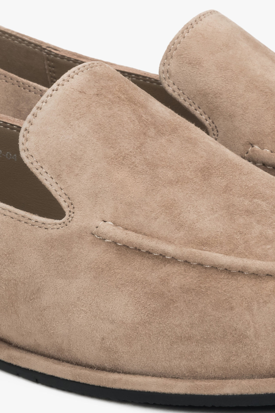 A pair of women's flat loafers made from genuine suede in a soft beige color, by Estro.