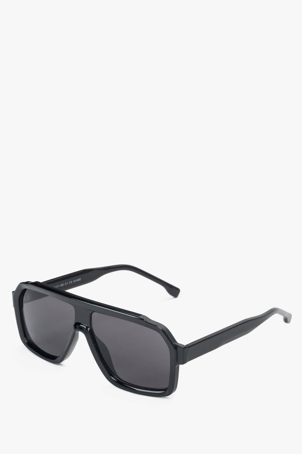 A pair of women's sunglasses by Estro, featuring a black geometric frame.