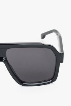 A pair of women's sunglasses with an angular black geometric frame, from the Estro collection.