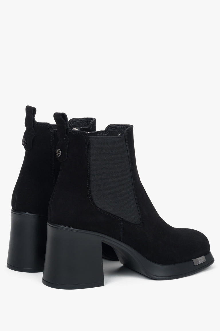 Side profile of a women's black suede ankle boot by Estro, highlighting the stable block heel design.