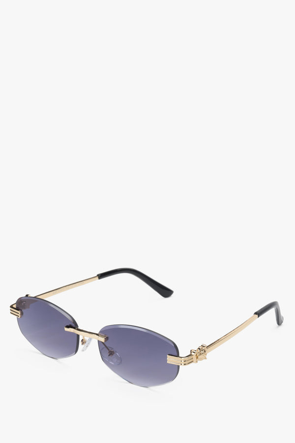 A pair of women's oval sunglasses by Estro, featuring a rimless design in grey and gold.