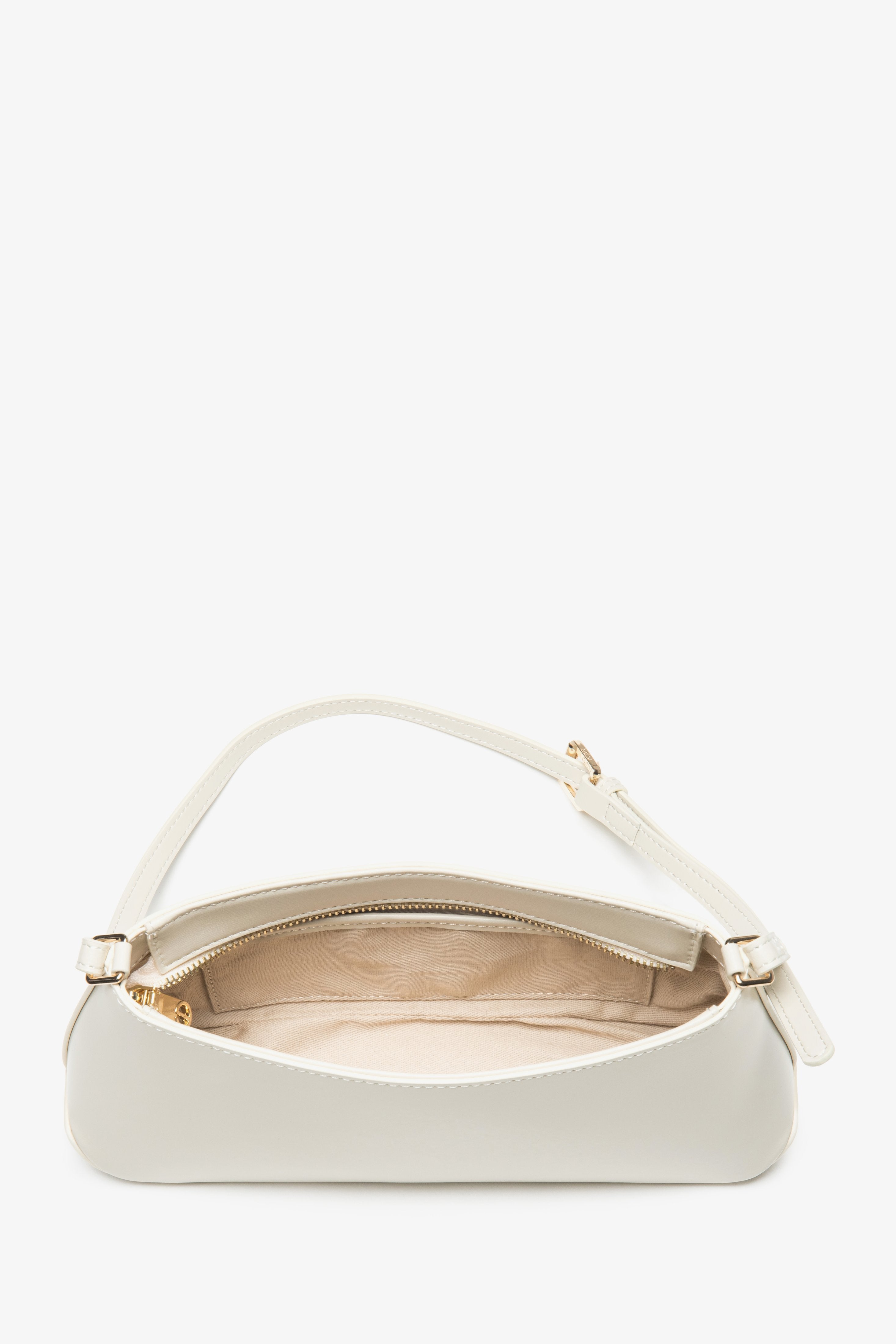 A women's shoulder bag crafted from classic genuine leather in a light beige color, by Estro.