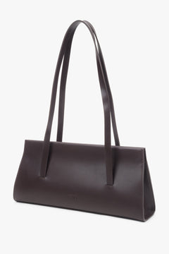 A saddle brown leather shoulder bag for women by Estro featuring long handles.