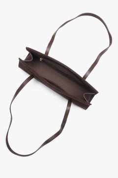A women's shoulder bag by Estro, crafted from soft saddle brown velour and designed with long handles.