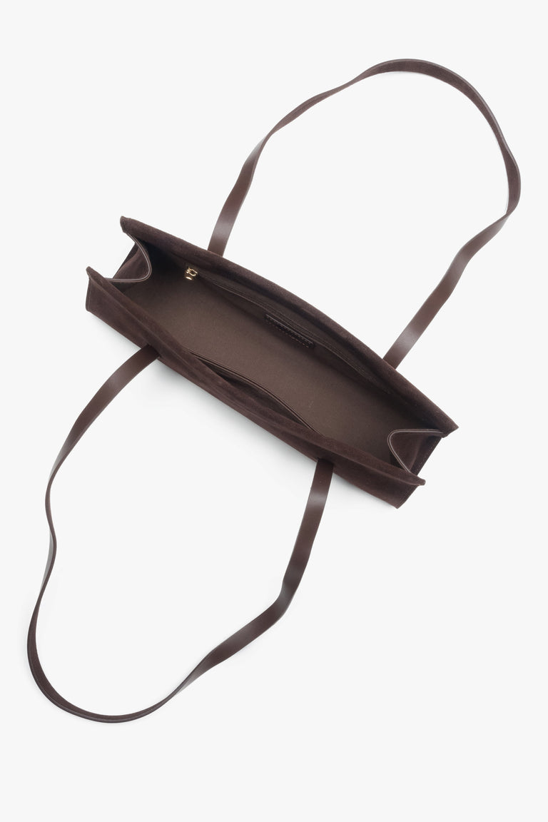 A women's shoulder bag by Estro, crafted from soft saddle brown velour and designed with long handles.