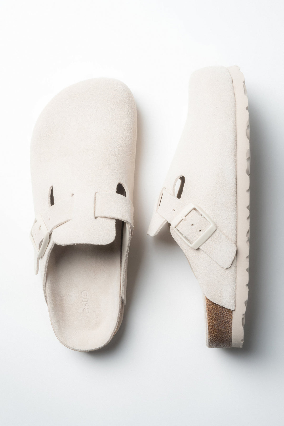 A pair of women's white slides by Estro, designed in a clog style with a soft genuine velour finish.