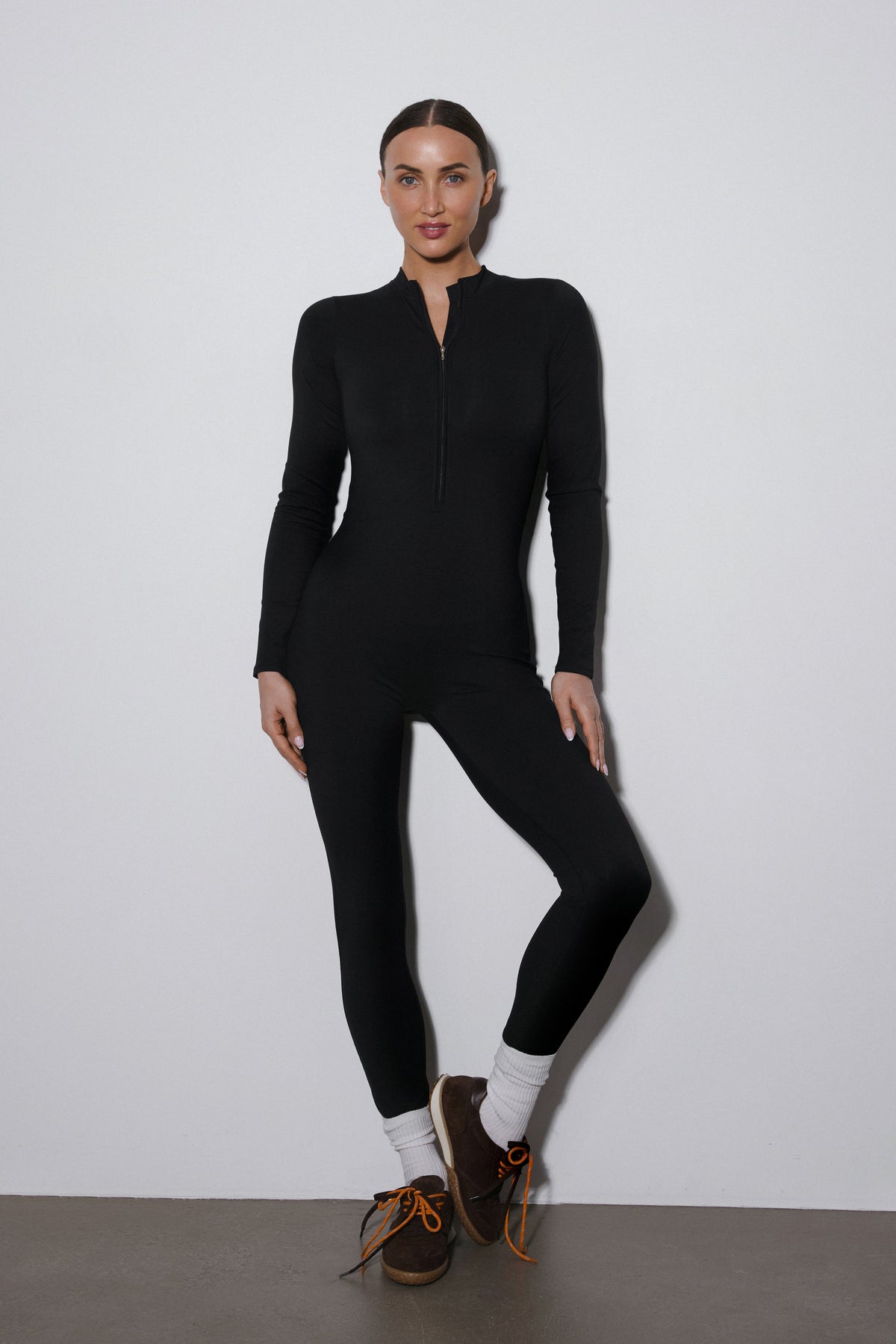 Black long sleeve sporty jumpsuit by Estro.