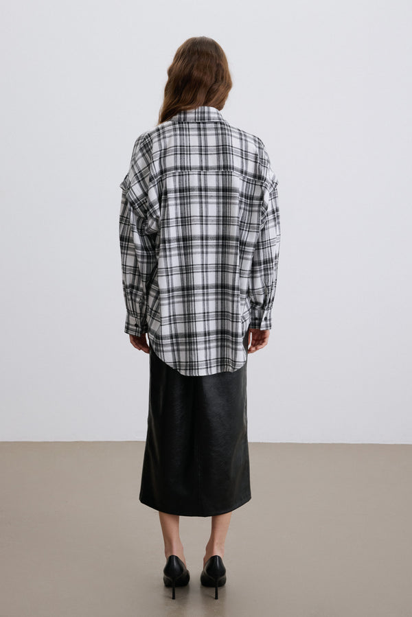 Back of women’s black and white checkered shirt.