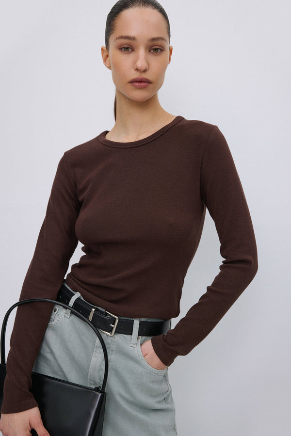 Model wearing Estro dark brown long sleeve top.