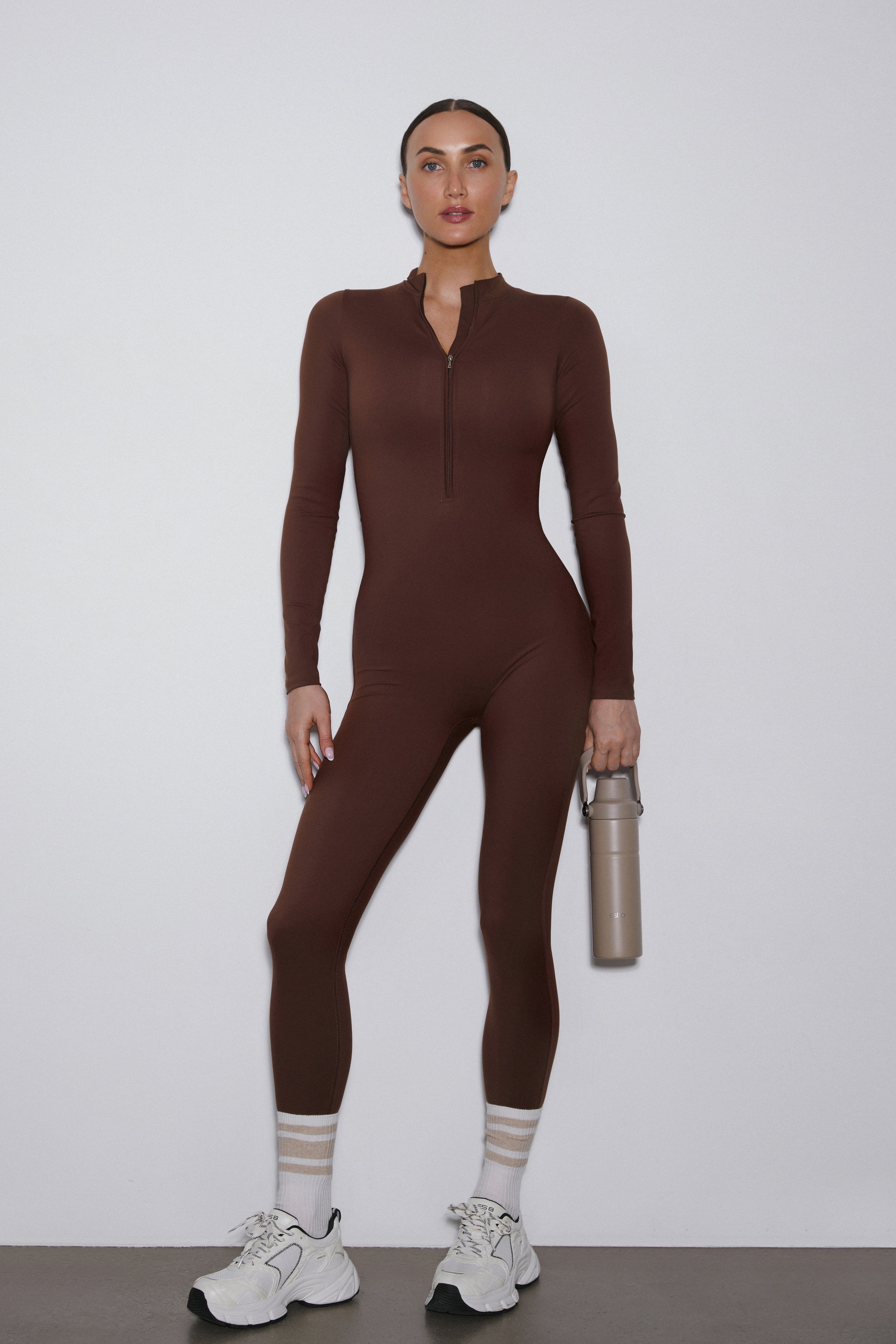 Dark brown long sleeve sporty jumpsuit by Estro.